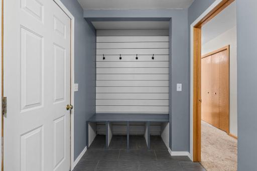 A convenient built-in drop zone helps keep coats, bags, shoes, and everyday essentials organized in the mudroom