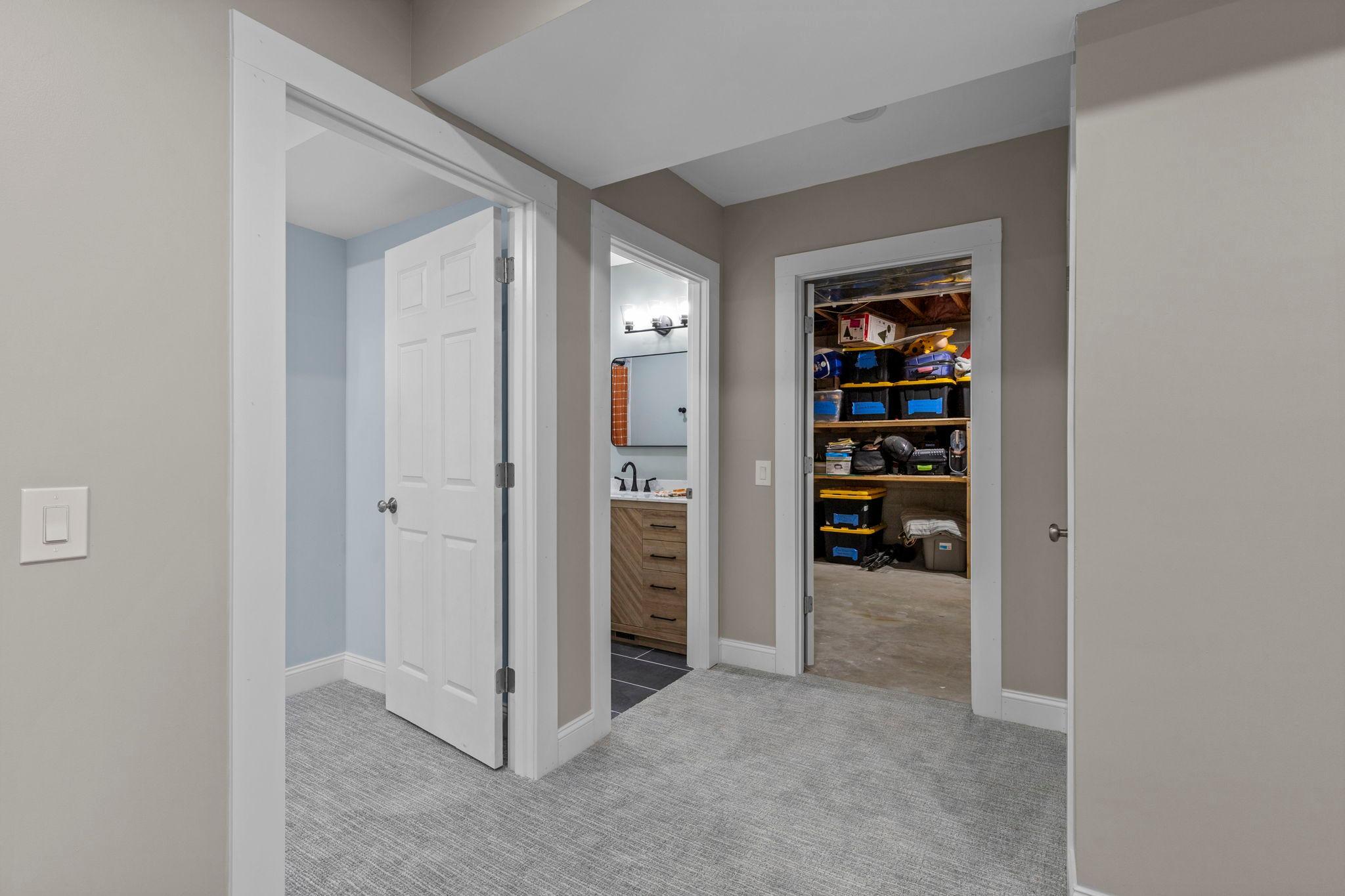 A thoughtfully designed lower level with convenient access to the bedroom, bathroom, and additional storage spaces
