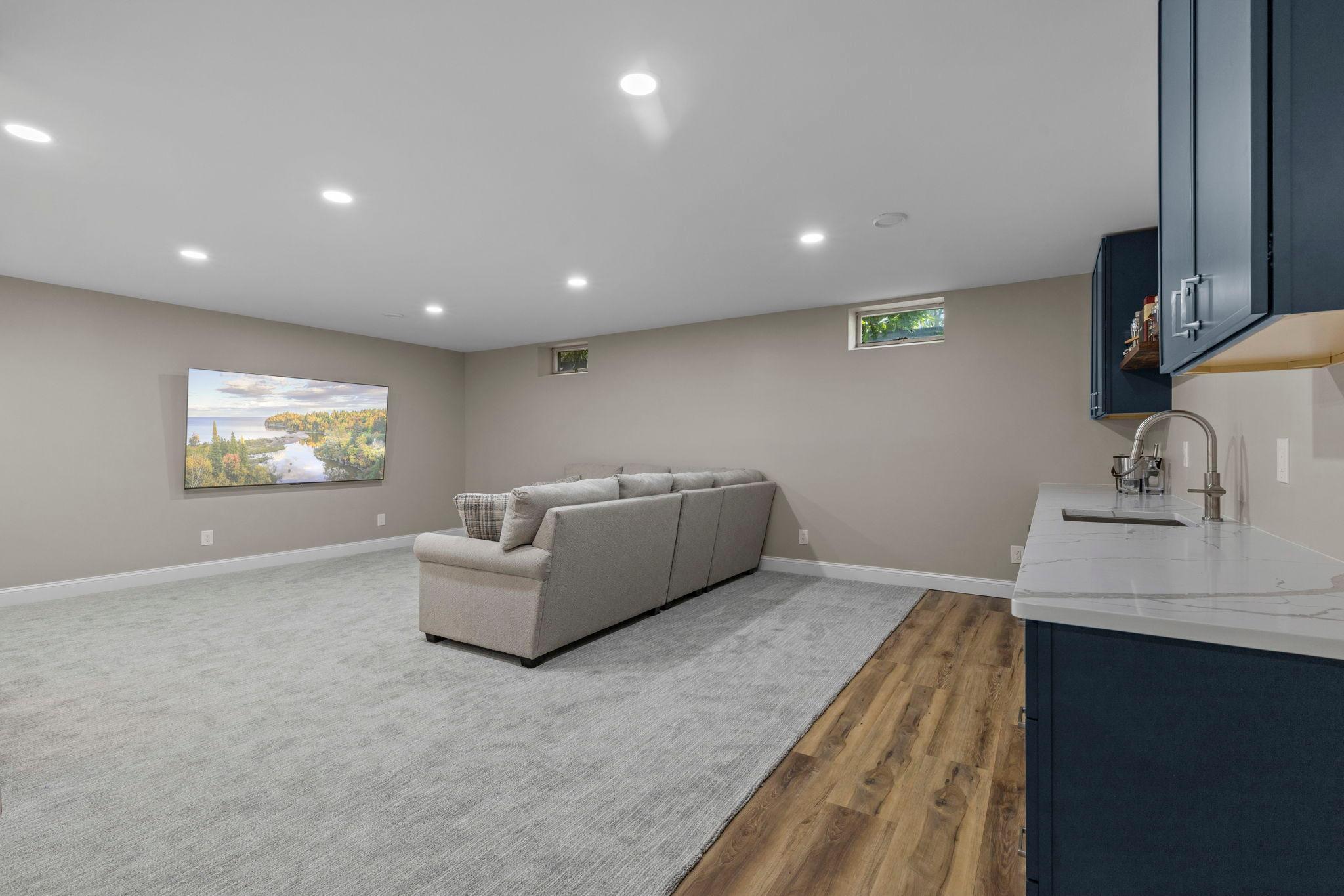Finished in 2026, the lower level feels bright and inviting with a spacious layout and plenty of room for gathering and entertaining