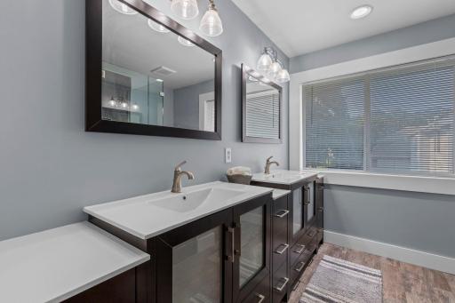 The updated primary bath offers plenty of vanity and storage space