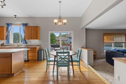 Sunny informal dining with a new sliding glass door leading directly to the deck and fenced backyard—perfect for meals inside or out