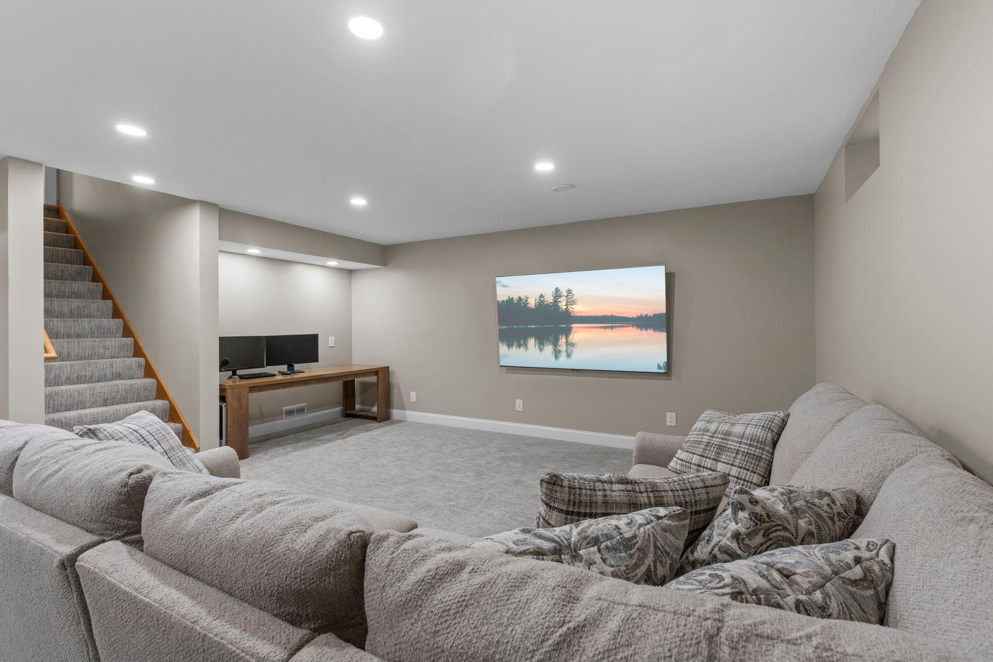 Plenty of room to spread out in the lower-level family room, complete with recessed lighting and fresh, modern finishes
