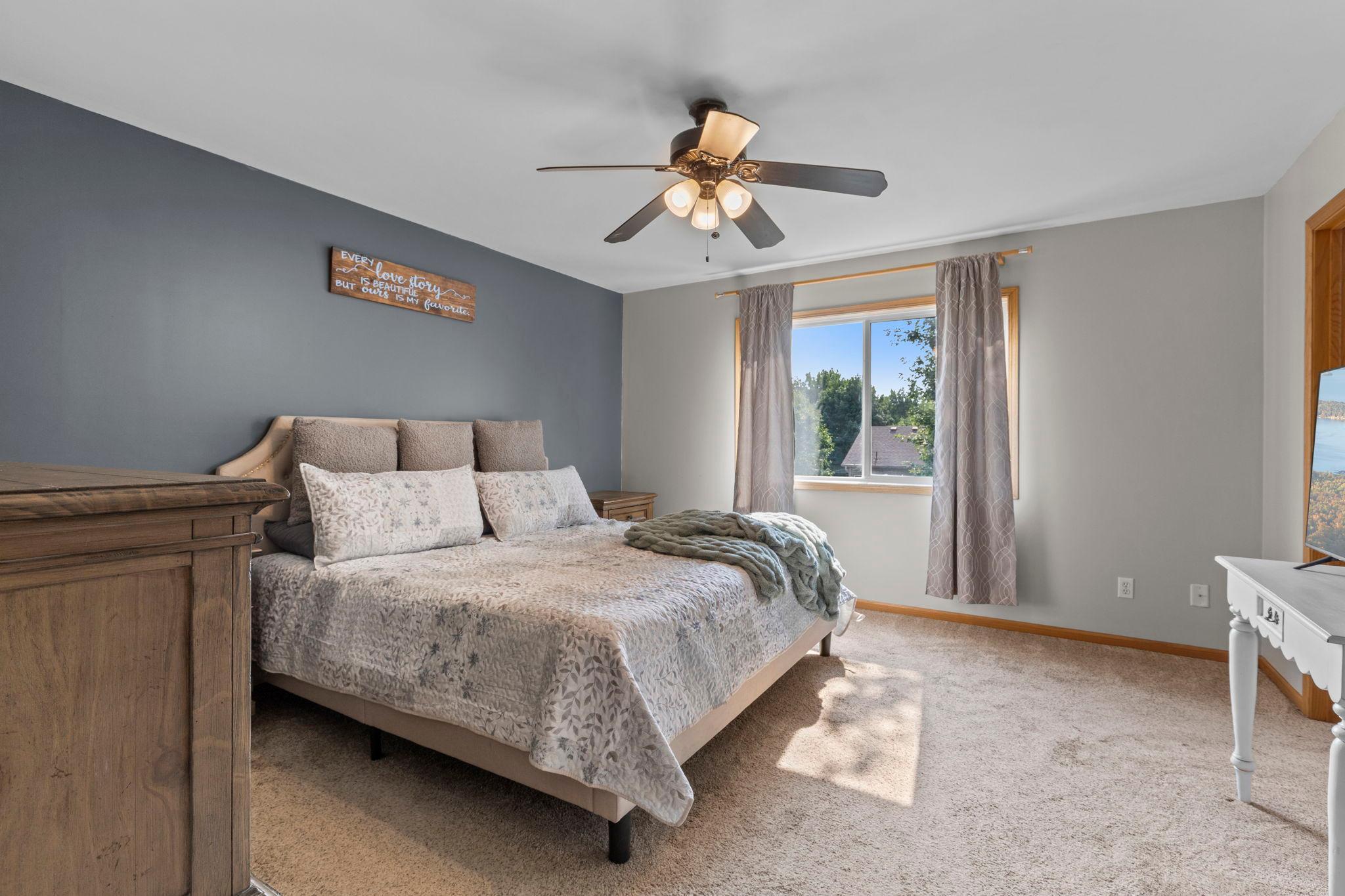 The spacious primary bedroom is filled with natural light and offers plenty of room to create a comfortable retreat