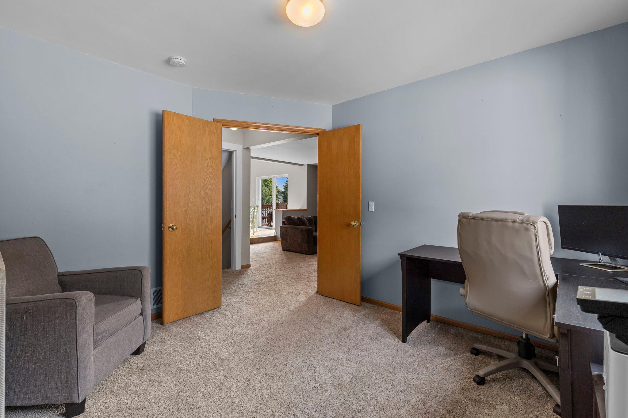 Double doors open to this flexible main-level bedroom/office, conveniently located near the main living areas and half bath