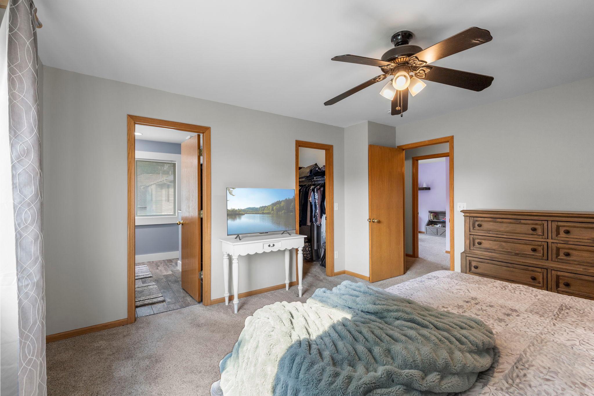 The primary suite offers convenient access to the private bath and walk-in closet