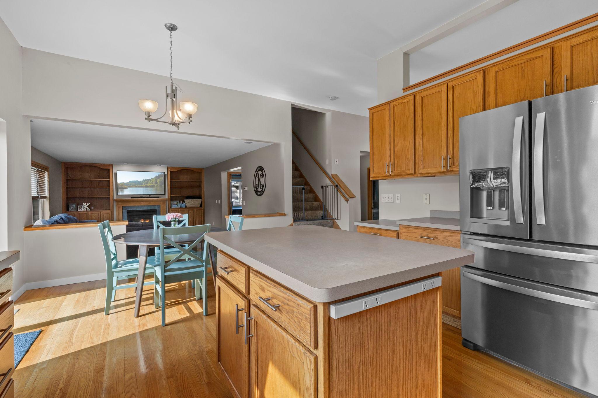 The center island provides plenty of room for meal prep and serving, with an open connection to the dining area