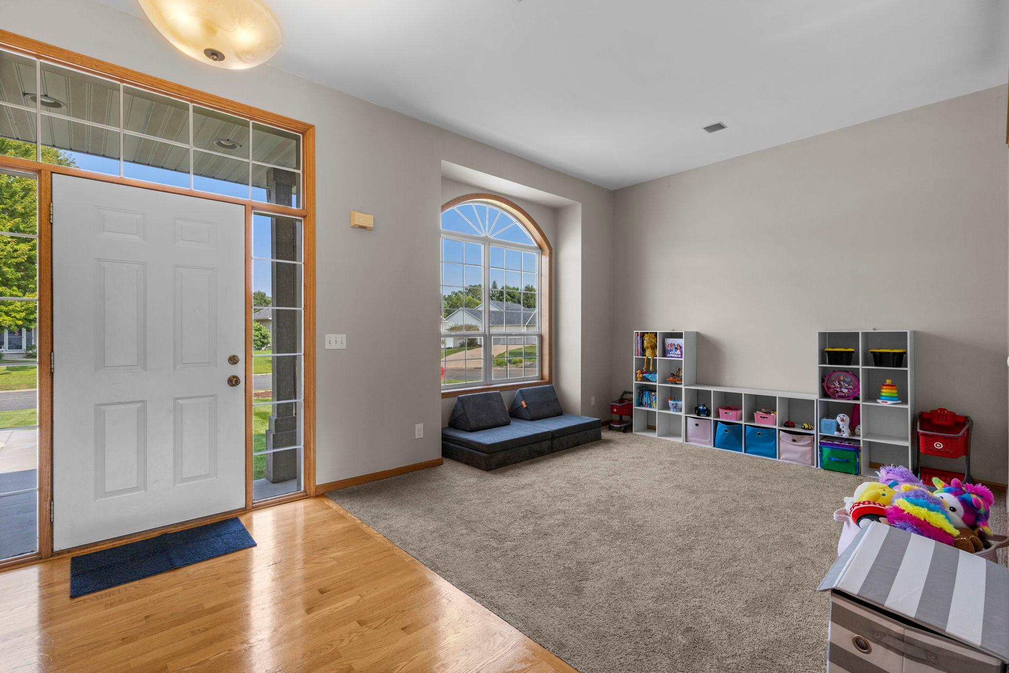 Step inside to a bright and inviting front living room, where a large arched window brings in plenty of natural light