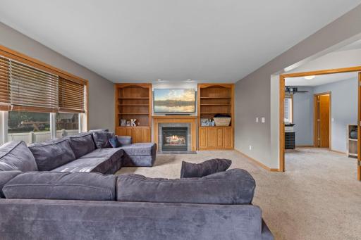 A cozy main-level family room with a gas fireplace and built-in shelving, creating a comfortable spot to gather and unwind