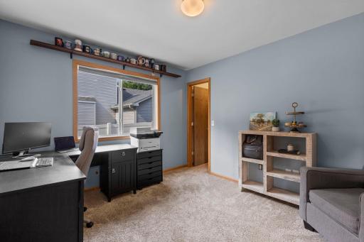Bright and comfortable, the main-level bedroom features a large window and plenty of space to easily function as a home office