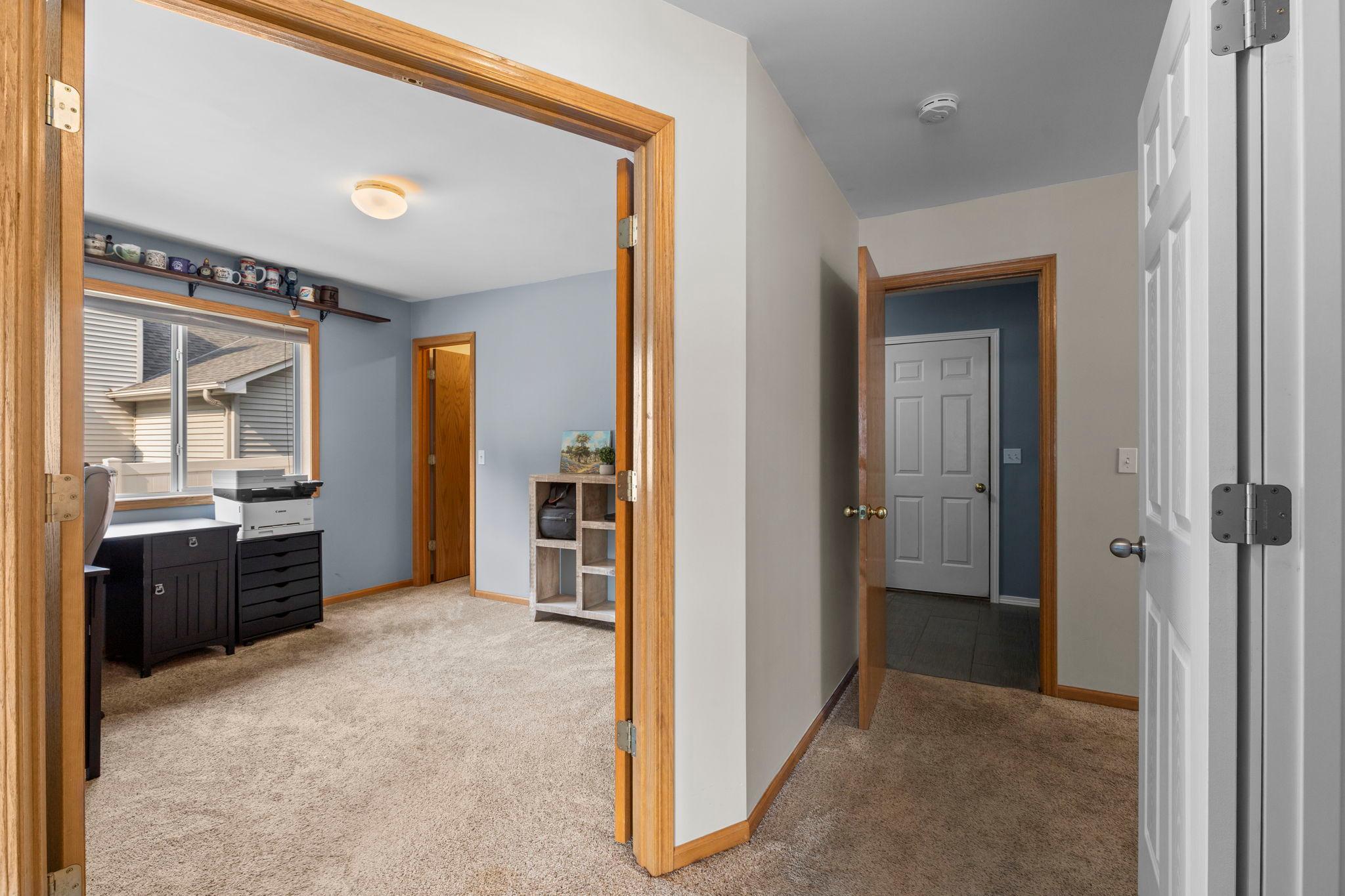 A versatile main-level bedroom offers great flexibility for guests, a home office, or additional living space