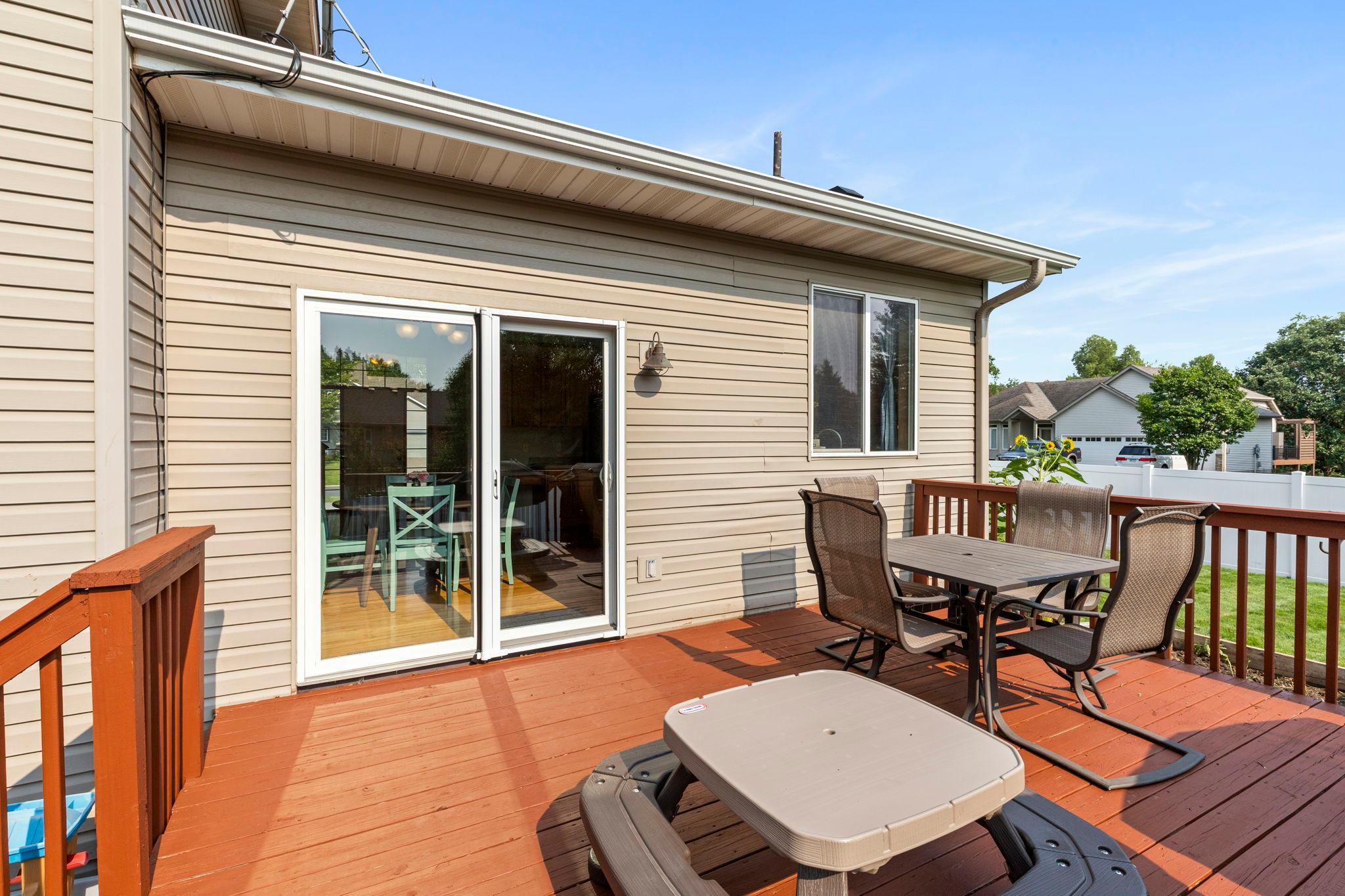 The deck provides plenty of room to relax and enjoy the backyard, with convenient access right off the kitchen and dining area