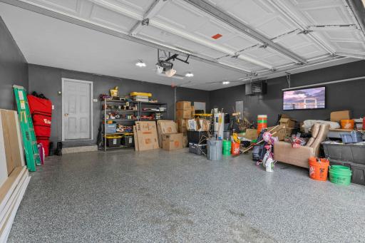 The heated, insulated, and finished garage is a standout feature with durable epoxy floors and plenty of room for vehicles, storage, and projects