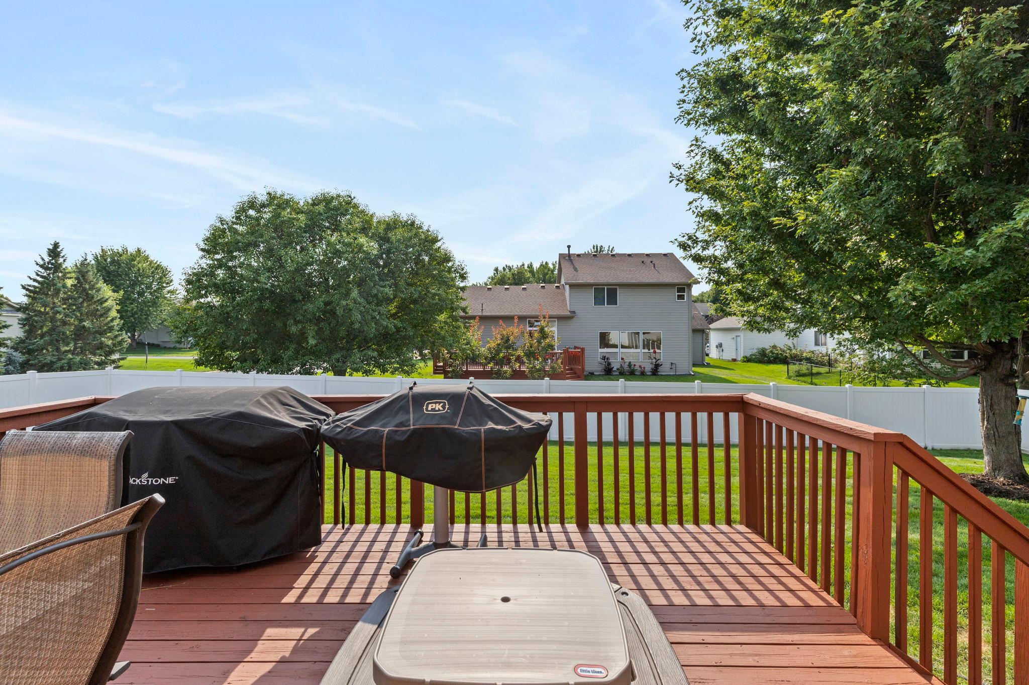 Step outside to the spacious deck overlooking the fully fenced backyard—a great setup for grilling, outdoor dining, and entertaining