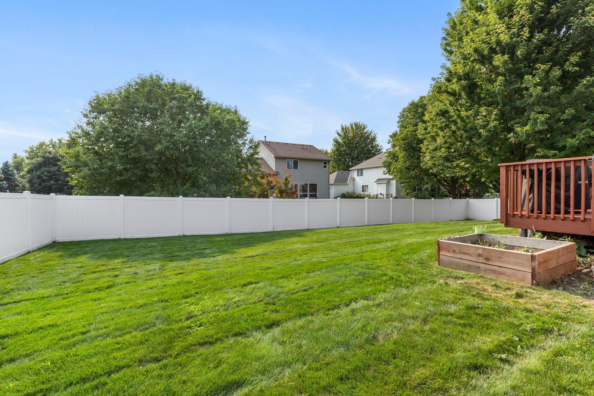 The new privacy fence surrounds a spacious backyard