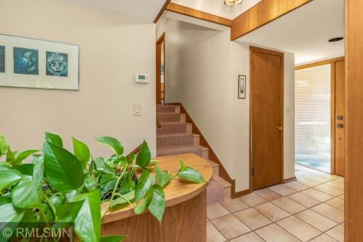 Entryway has a coat closet as well as a small nook for a table or shelf.