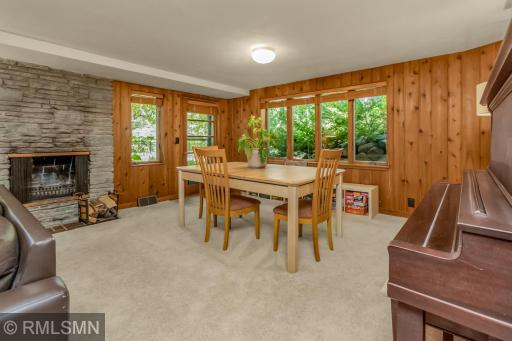 Large windows with views of the back yard and gardens.
