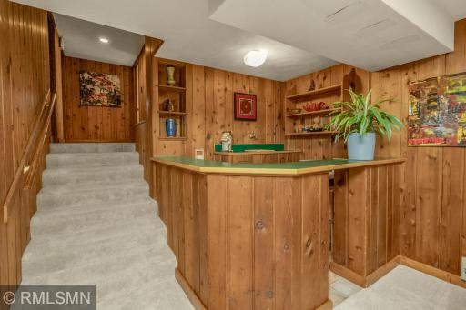 Stairs lead to the lower level bedrooms. Original wet bar!