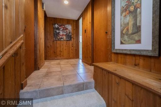Hallway leads to laundry, utility room, garage, and finally two bedrooms and a full bath.