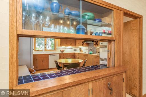 Pass through to the kitchen, with original wood accordion closure.