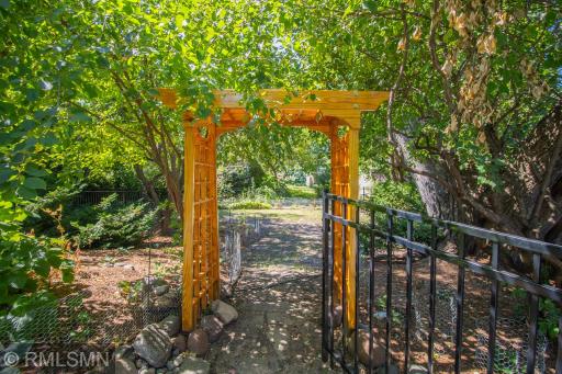 Gate and arbor leading to the private, sheltered back yard.