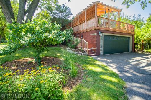 Stairway leads up to the deck, which sits on top of garage. Note the glass block sidelights on each side of the garage door.