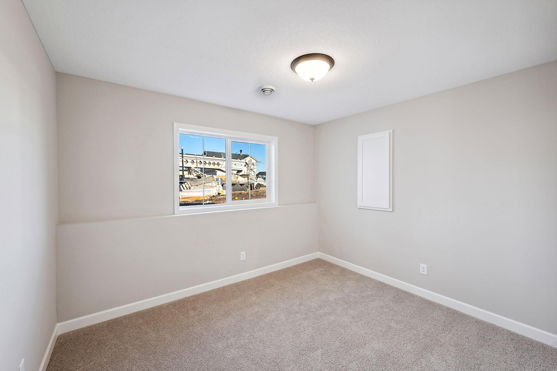Lower Level Bedroom - photo of a staged model home of the same floorplan. Selections may be different.