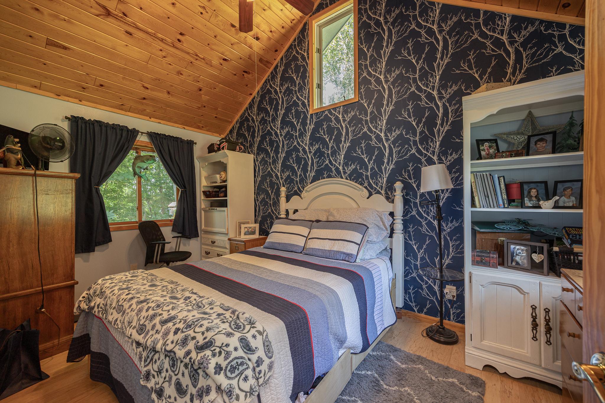 Main home bedroom with vaulted ceilings