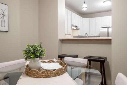 The kitchen breakfast bar provides additional seating for quick meals, morning coffee, or visiting with guests while preparing dinner.