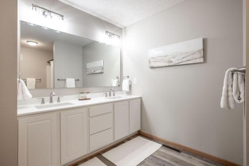 Remodeled Full Bathroom with new flooring, vanity, lighting, and hardware!