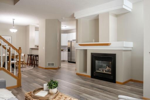 Welcoming family room featuring a cozy gas fireplace and an open-concept design perfect for everyday living.