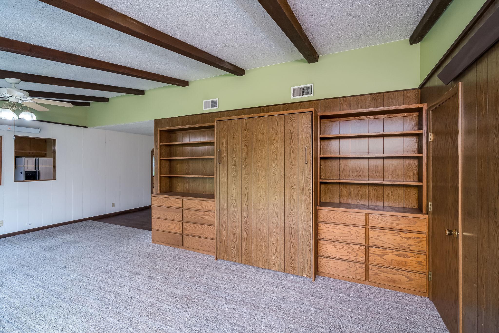 Built-in shelving until with trundle Bed in the middle to turn your family room into a guest room when needed