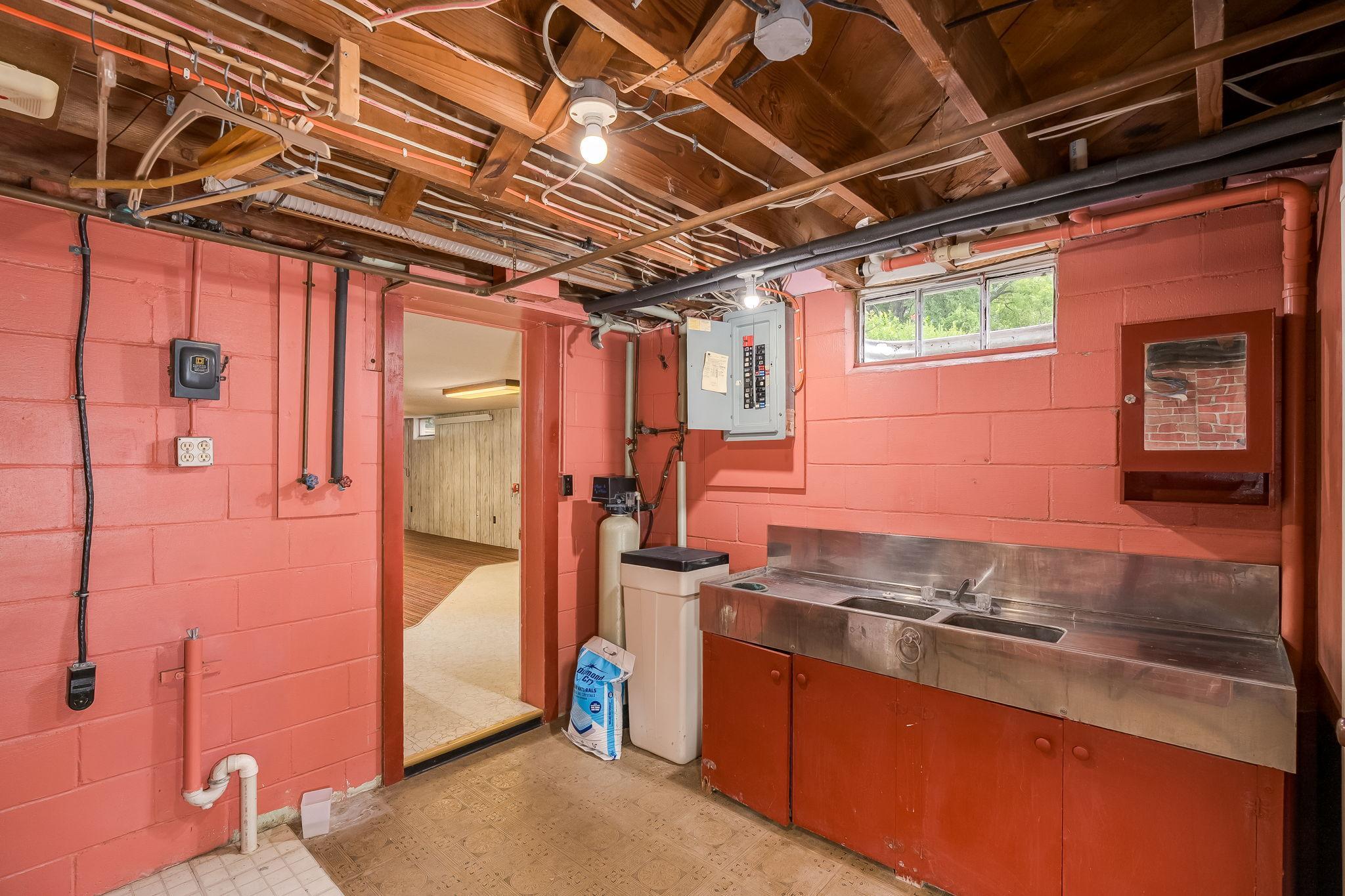 Water softener up to date electrical and an area that could easily be turned into a second kitchen for a rental unit.