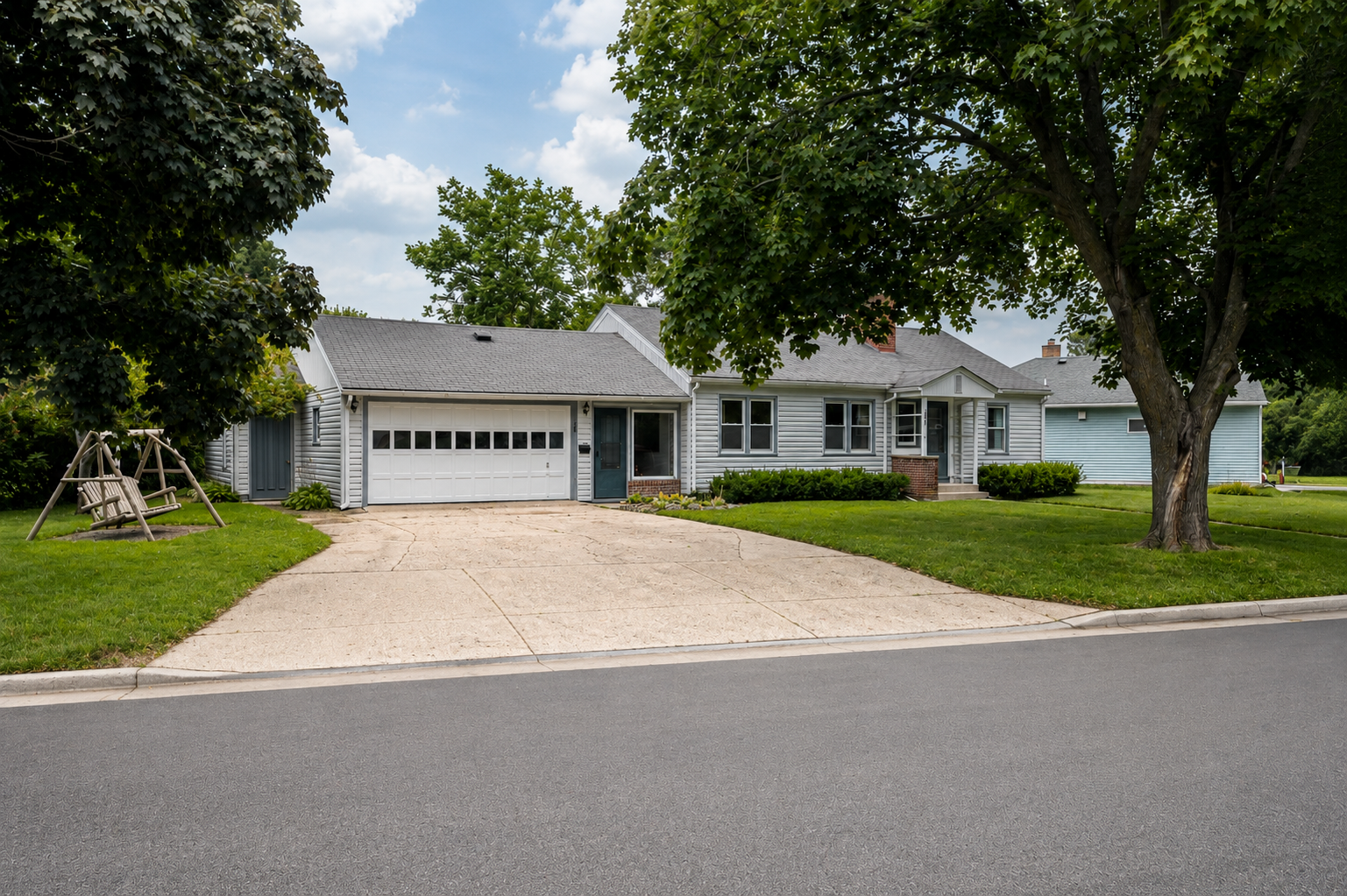 Concrete driveway, side separate entrance going to basement, two front entrances.
