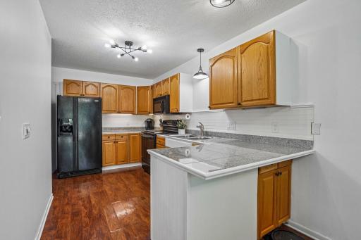Ample counter space with additional seating at the breakfast bar.