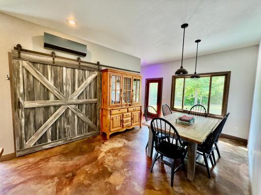 Open dining area with barn door pantry