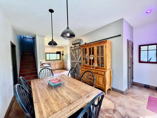 Dining to kitchen, stairway to upper, 1/2 bath on right