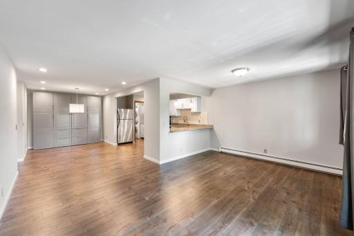 Living area looking into dining and kitchen