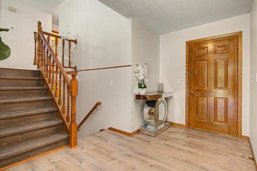 Welcoming split-entry foyer with updated flooring and natural wood accents.