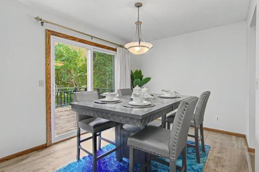 Dining area with updated flooring and direct access to the deck.