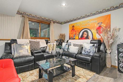 Cozy lower-level sitting area with recessed lighting.