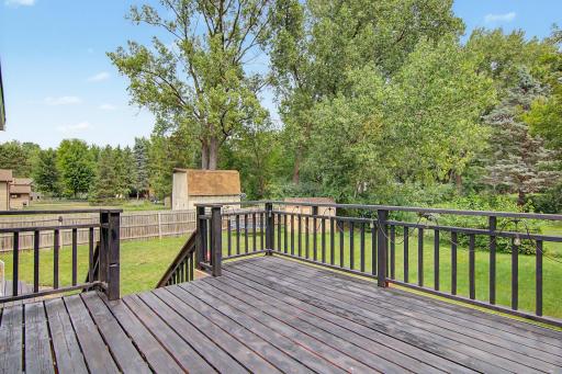 Spacious deck overlooking the tree-lined backyard—perfect for relaxing or entertaining.