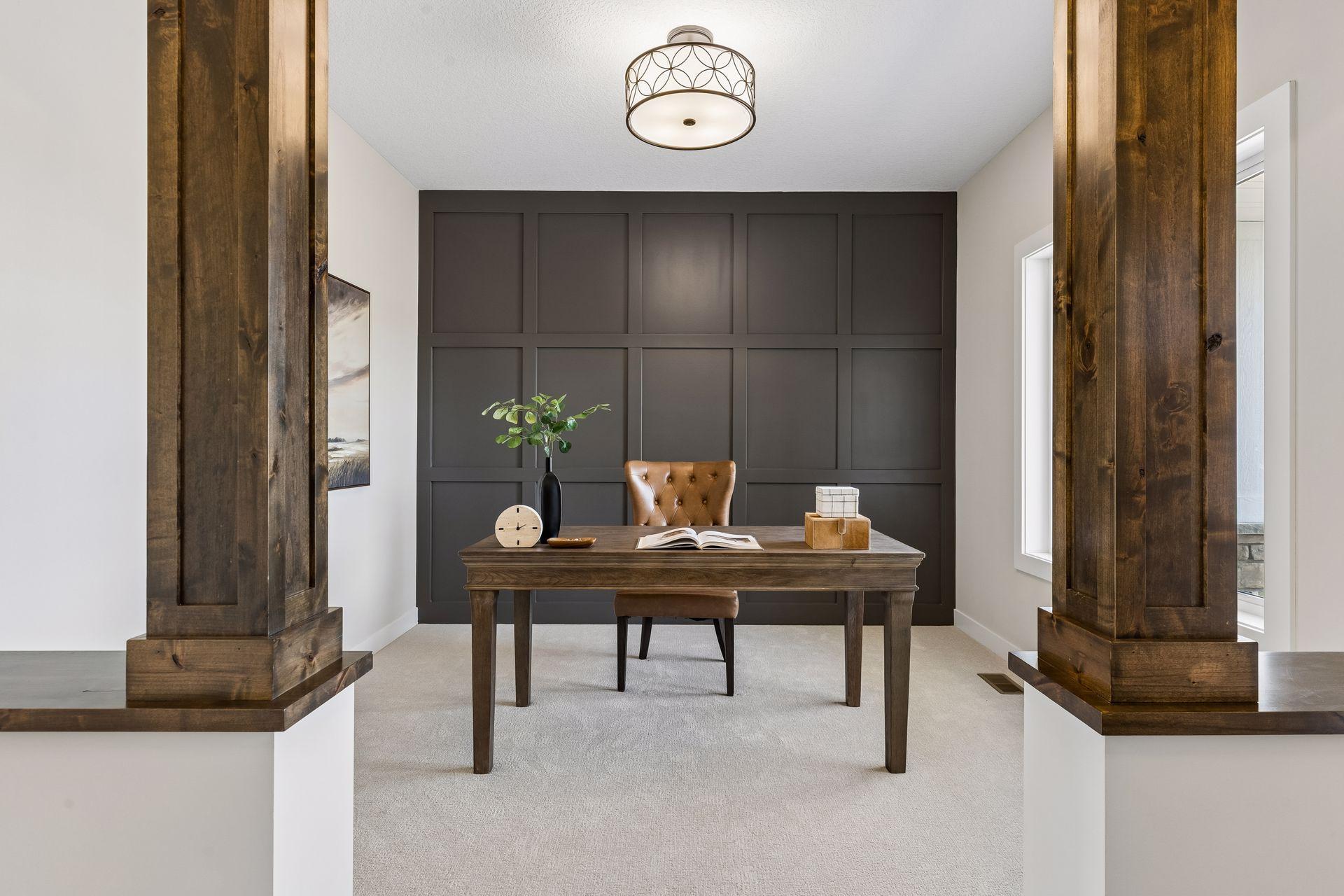 A stunning den with accent wall and pillars!