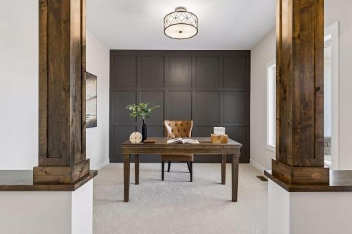 A stunning den with accent wall and pillars!