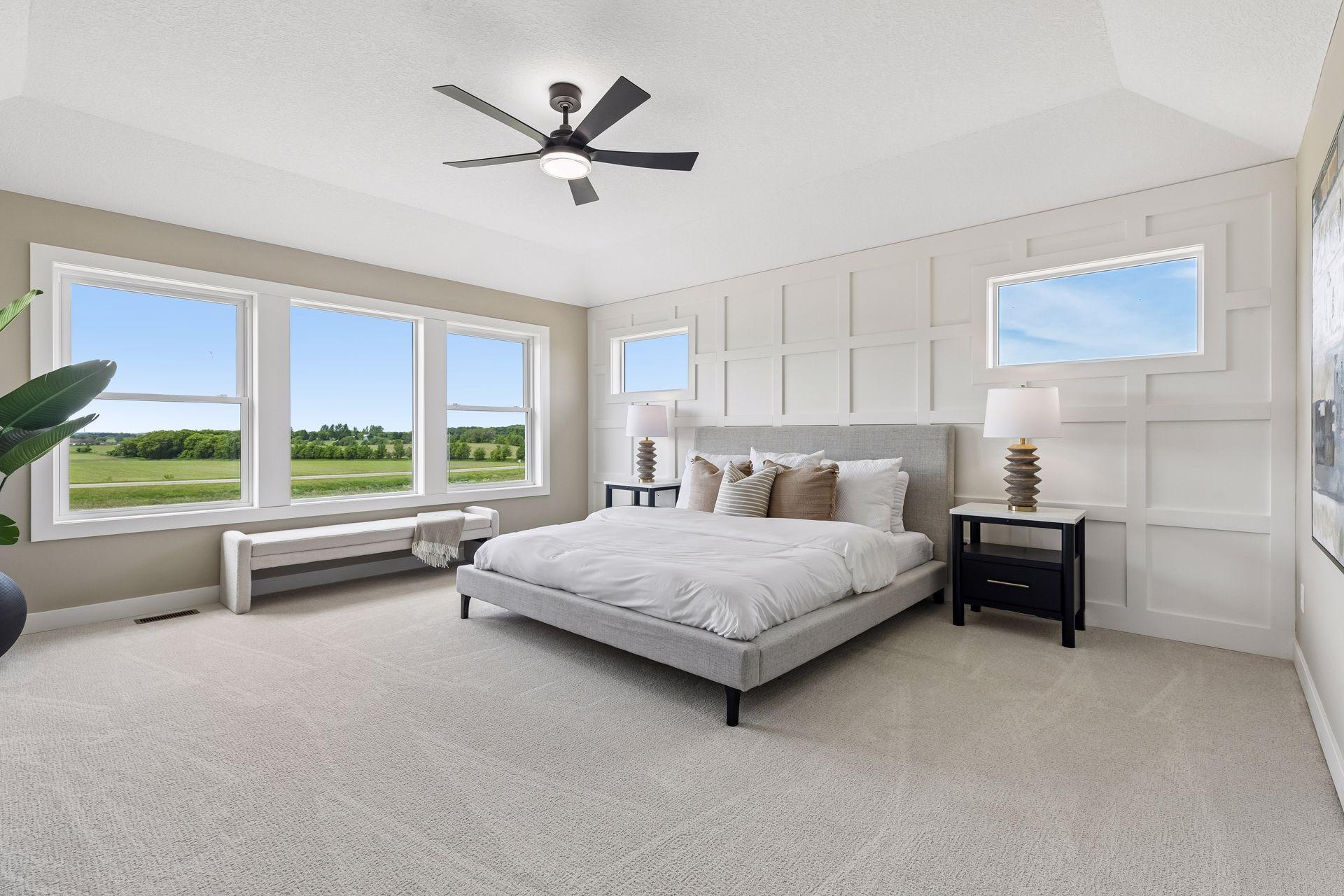 This spacious primary suite features a stylish, on-trend accent wall and beautiful views of the backyard!