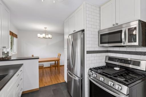 Floor to ceiling tile & stainless appliances