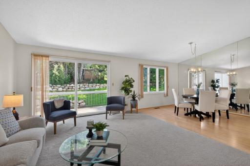 Living room and dining room with access to deck