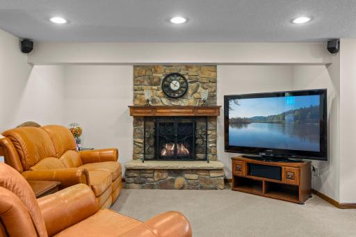 The walkout lower level's family room features a stone fireplace, the third in the home, and plenty of room to gather.