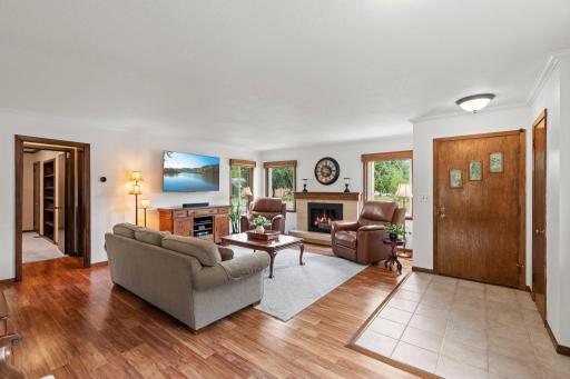 The welcoming living room sits just off the front entry, anchored by a woodburning fireplace and filled with natural light.