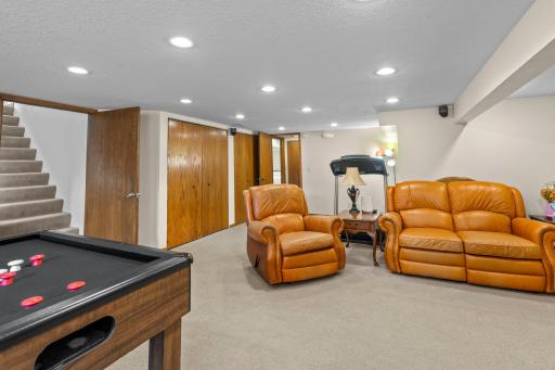 The finished lower level's flexible layout leaves room for a home gym area alongside the family and game rooms.
