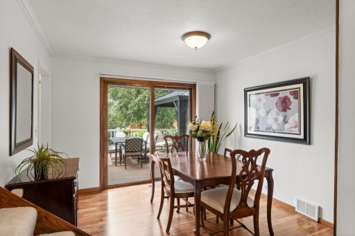 The formal dining room enjoys backyard views and direct access to the deck through sliding glass doors.